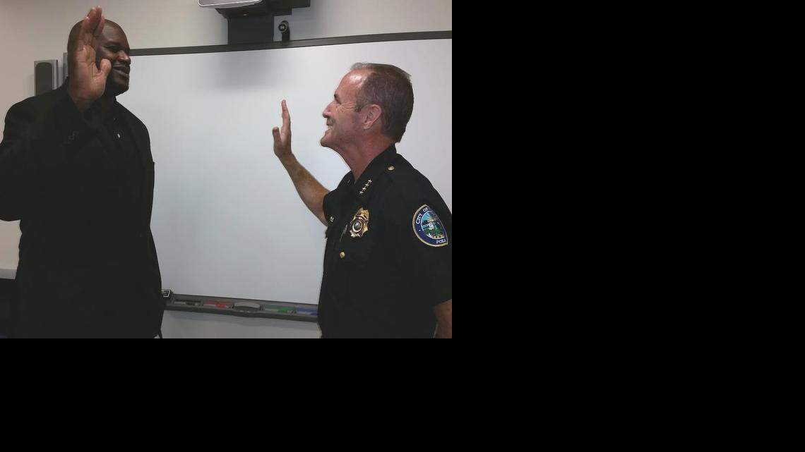 
Former Miami Heat star Shaquille O’Neal is sworn in as a reserve police officer by Doral Police Chief Donald De Lucca at the Doral police department Tuesday afternoon.
