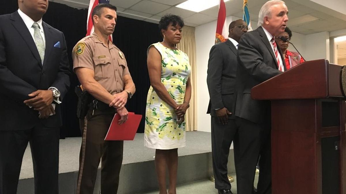 Carlos Gimenez addresses the media during a press conference at Miami-Dade’s police headquarters in Doral. Joining him from left to right are Morris Copeland, the county’s director of juvenile services, Juan Perez, county police director, and county commissioners Audrey Edmonson, Dennis Moss and Barbara Jordan.