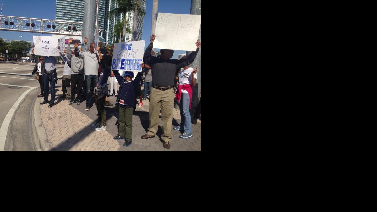 
Protesters organized by Fountain of New Life church in Miami Gardens reach out to passersby near the Freedom Tower on Biscayne Boulevard in downtown Miami on Saturday, Dec. 13, 2014.
