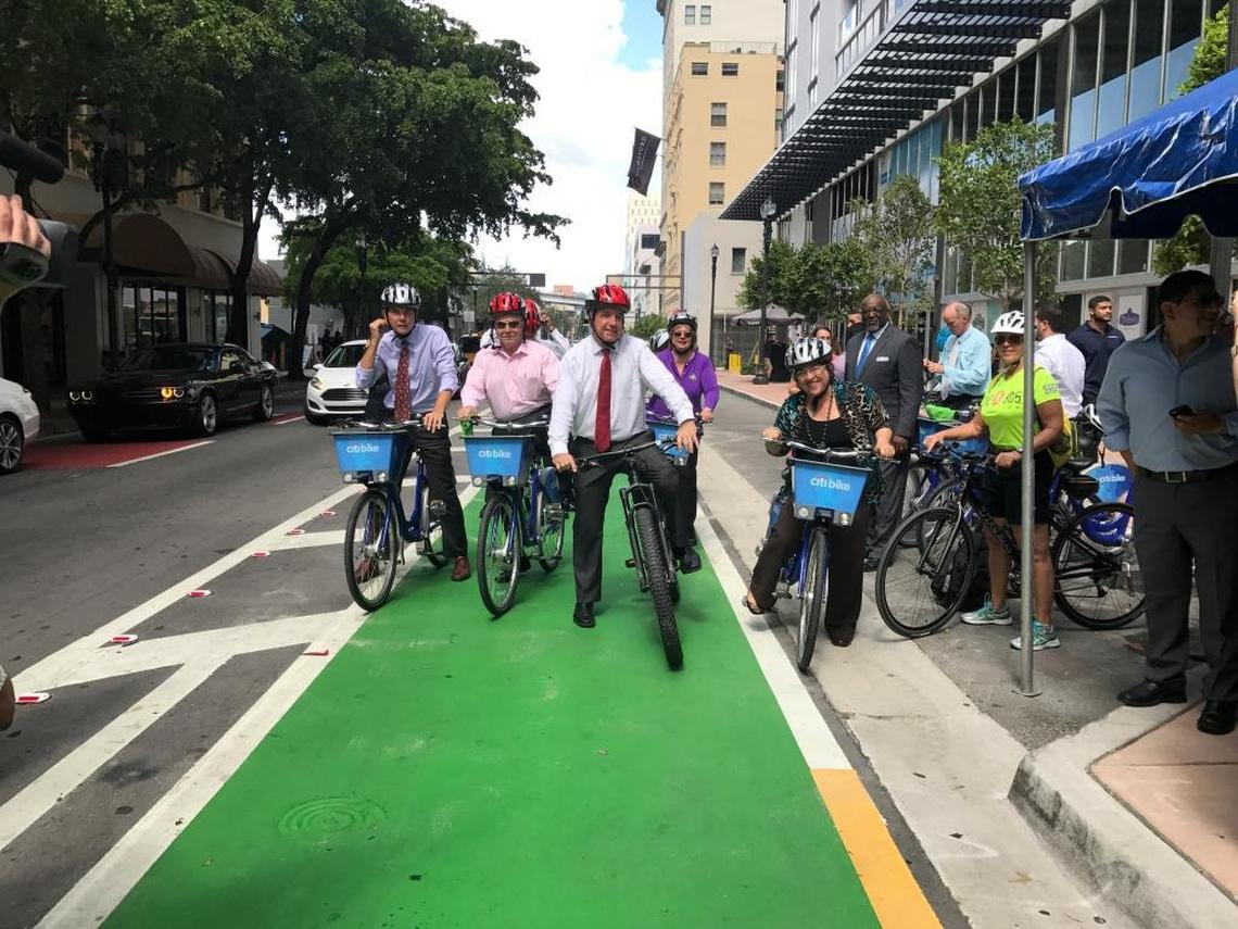 Getting ready for a test ride of the new bike lane in downtown Miami atop their Citibikes on Thursday are (forefront, left to right) Miami commissioners Ken Russell and Willy Gort, Miami-Dade Mayor Carlos Gimenez and Miami-Dade Commissioner Daniella Levine Cava.