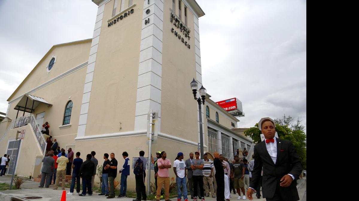 
Dozens wait outside the historic Mount Zion Baptist Church in Overtown to see Louis Farrakhan speak Wednesday, July 30, 2015.

