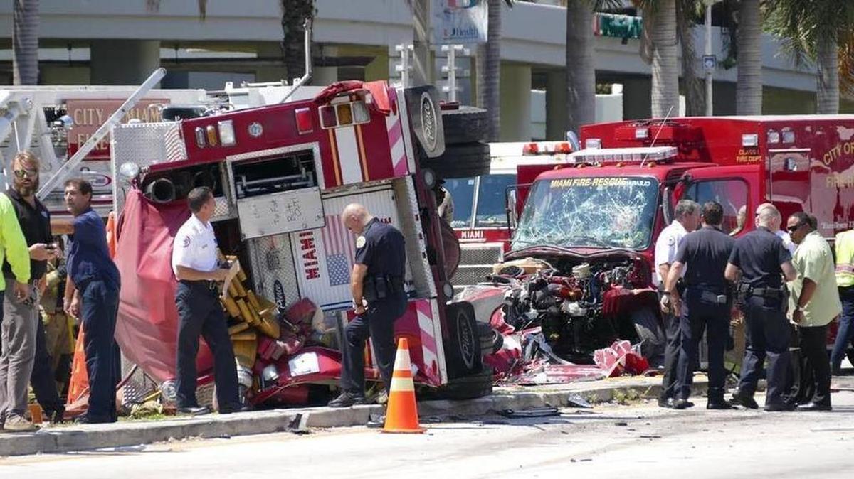 
Officers and rescue personnel work on the scene of a major crash involving two fire trucks in Miami Tuesday near Jackson Memorial Hospital.
