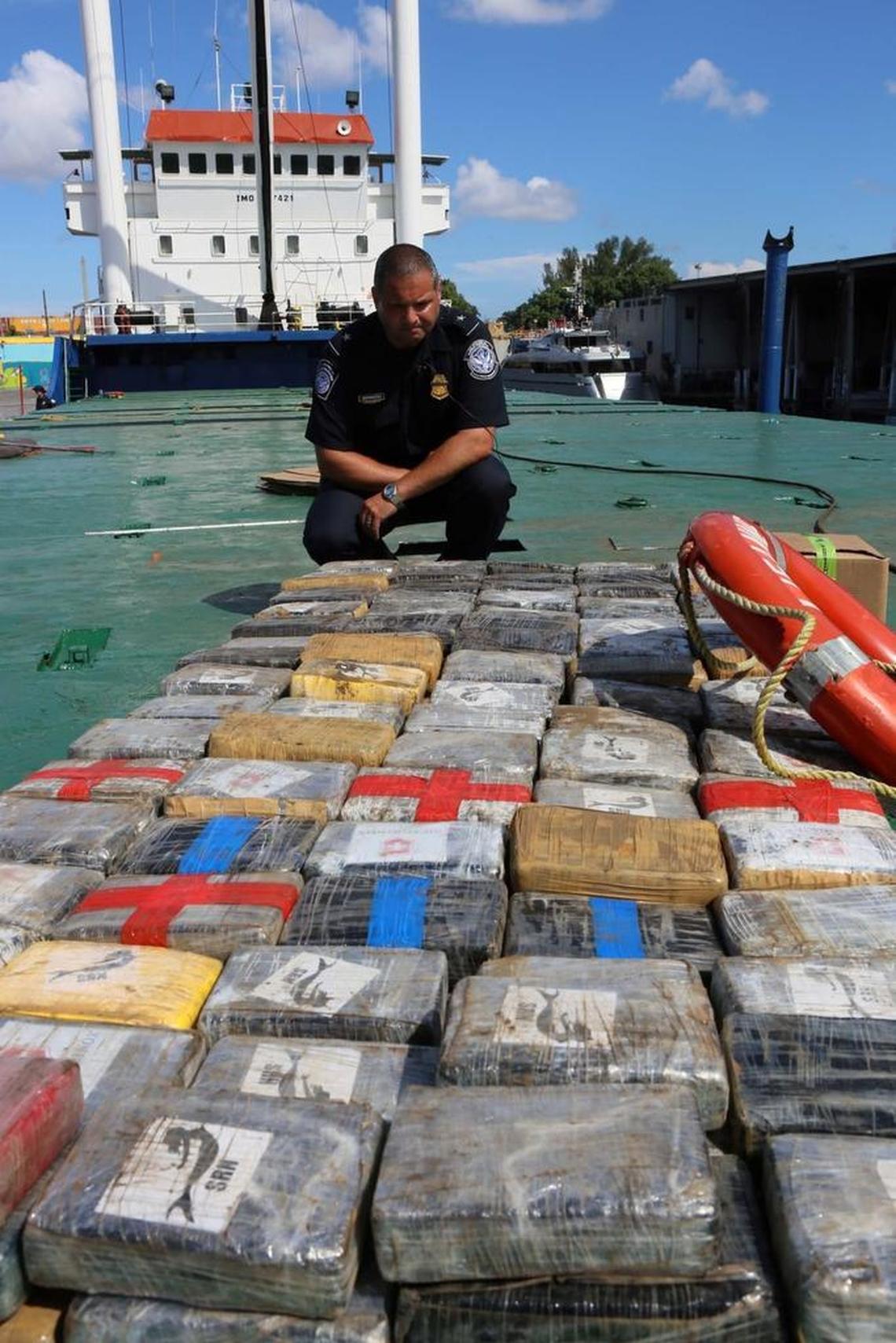 Dylan J. DeFrancisci, port director for U.S. Customs and Border Protection, is shown in 2016 with 2,000 pounds of cocaine that was hidden on a Haitian freighter on the Miami River, the biggest drug bust in more than a decade.