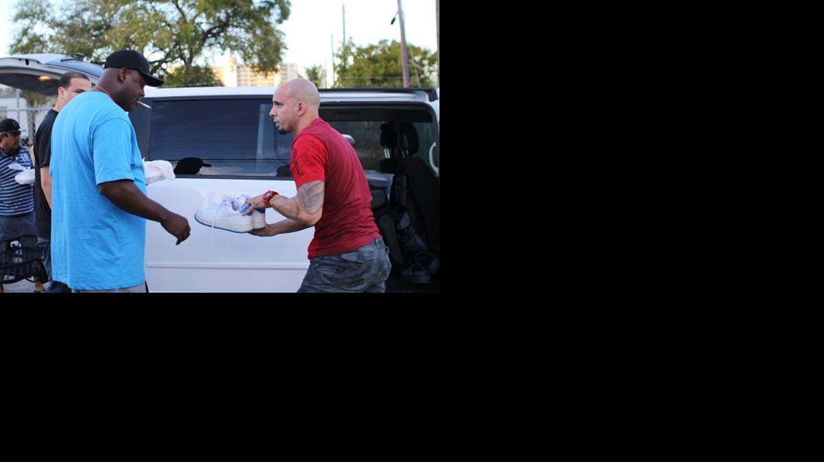 
Camillus House resident Kevin Brown receives a pair of shoes from Shoes for Streets founder Gabriel Varona during a distribution. Shoes for Streets, a nonprofit organization, mission is to give shoes to those in need.
