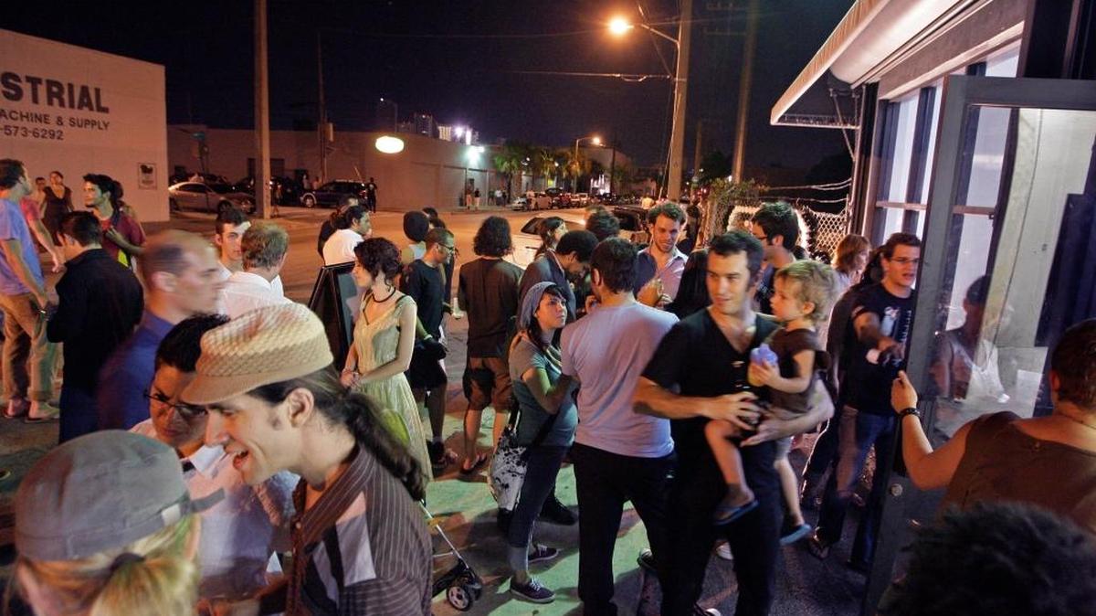 A young crowd gathers on Northwest Second Avenue in Wynwood, where business boosters and police are pushing back against reports of a terrorist threat during art week.