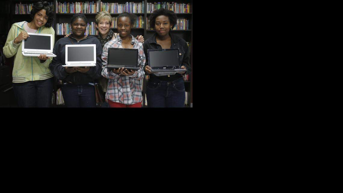 
(Left to right) Jurmelle, 17, Davona, 14, Dayna Steele, Bodactious, 17, and Tabitha, 16, after Dayna Steele gave them Google Chromebooks in Miami on Friday, Nov. 28, 2014.
