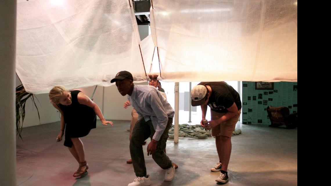 
Kelly Eriksen, Ezekiel Binns, center, Theo Rodino, right, and Matthew Alvarez, back, are walking underneath one of the art pieces they created in Locust Arts Builders, a three-week summer intensive program where students collaborate as both artists and curators to create an art exhibit from scratch. Their work is on display at Locust Projects, a non-profit gallery space in Miami’s Design District.
