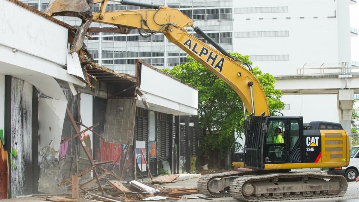 
A track hoe tears at the last remaining building on the future site of Miami Worldcenter, Thursday, Sept. 3, 2015, in Park West. Miami Worldcenter will include residential and retail spaces as well as restaurants and hotels.

