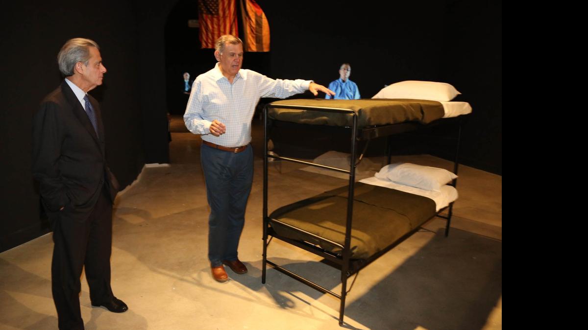 
Tony Argiz (left) and former Sen. Mel Martinez visit the exhibit ‘Operation Pedro Pan: The Cuban Children’s Exodus’ at HistoryMiami. Both recall sleeping on bunk beds like those that are part of the exhibit.

