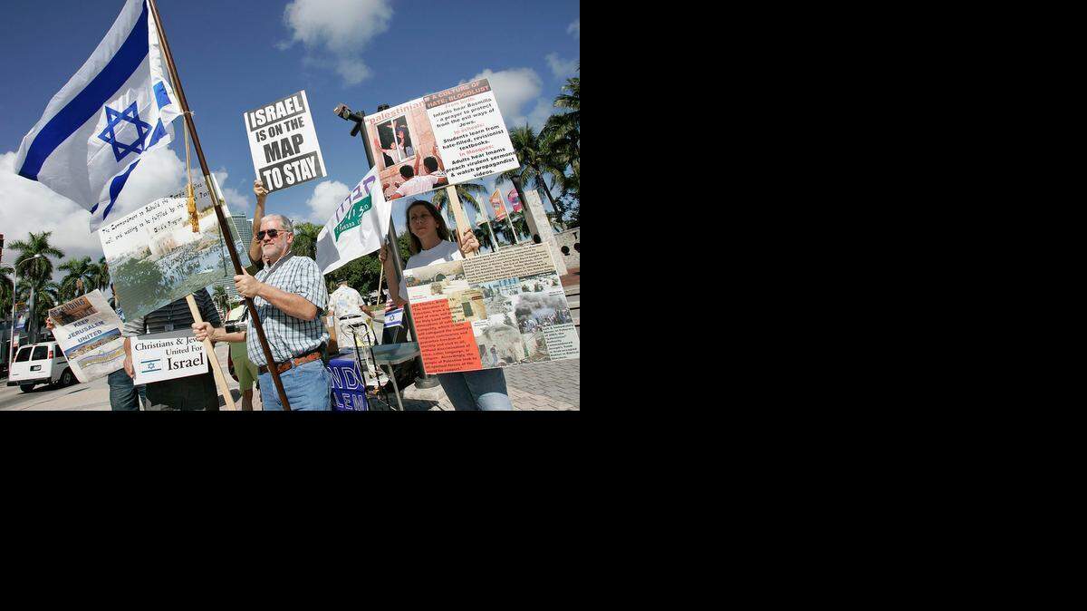 
In this file photo from Jan. 10, 2008, Ed Warmoth, Executive Director of Builders of Zion and his wife Sandra, International Relations Director of the same group hold rally with Shalom International, Coalition to Defend Jerusalem and other groups to oppose of surrender Jewish lands and for unification of Jerusalem at “Torch of Friendship.” Shalom International is planning protests at the same location Sunday and Tuesday to condemn the current talks between Iran and the United States over Iran’s nuclear program.

