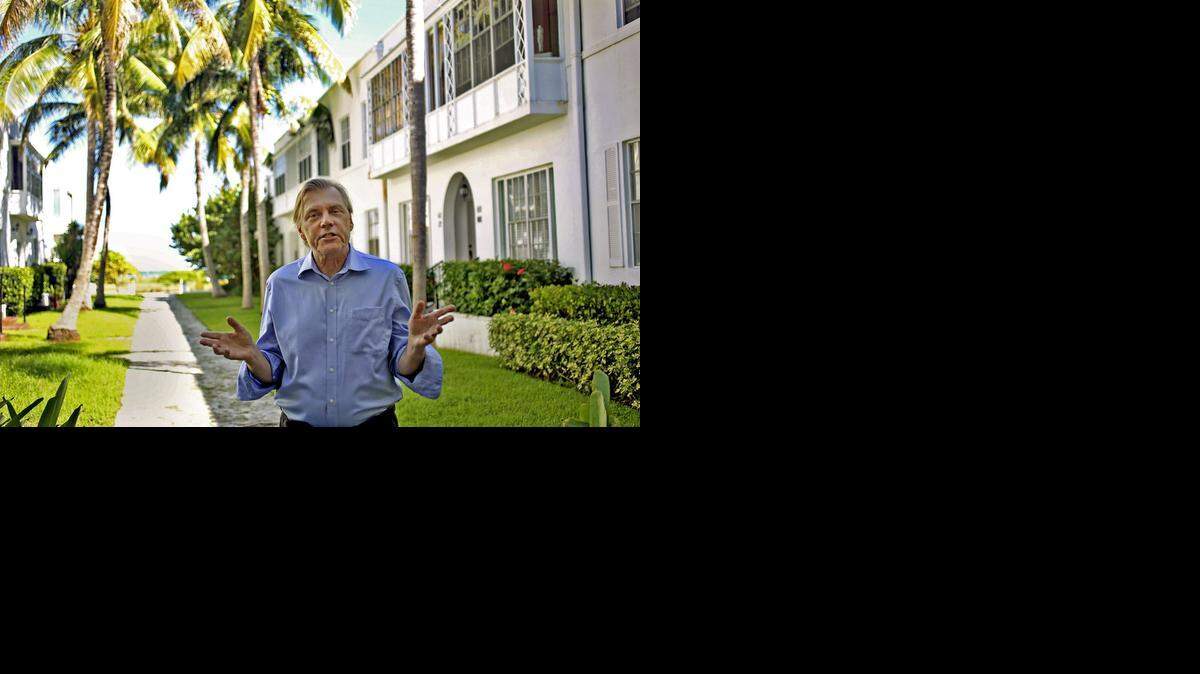 
Stephen Norris, a 20-year owner and resident of a condominium at The Seaway Villas in Surfside, stands in the courtyard of the condiminium on Thursday Oct. 16, 2014, and talks about the architectural gem of the 29-unit building. 
