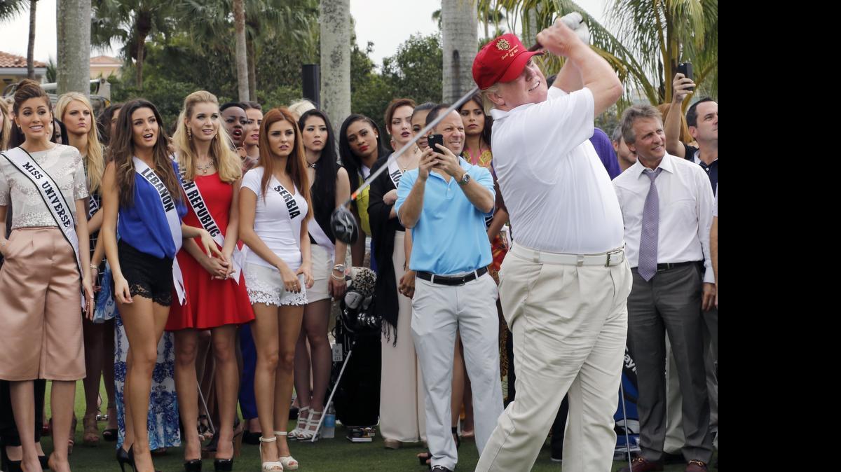 
Donald Trump tees off on the Red Tiger golf course at the Trump International Doral Miami resort on Jan. 12, 2015. Contestants in the Miss Universe pageant, a Trump event, are among the spectators. 
