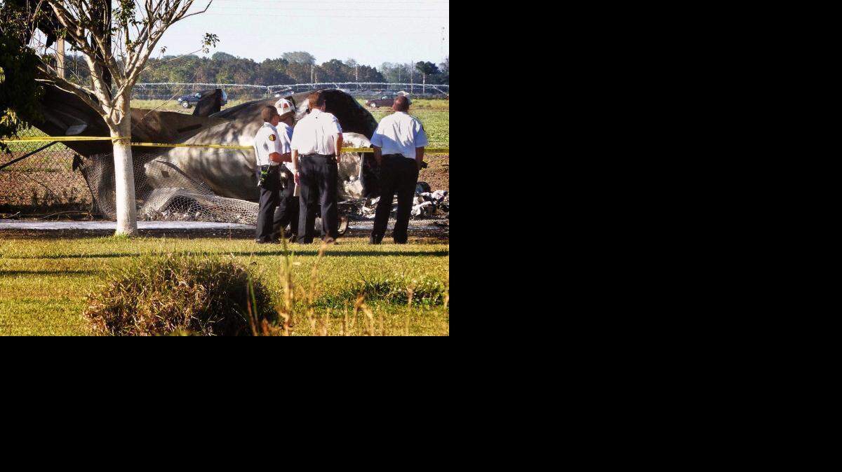 
INVESTIGATION: Officials from Miami-Dade Fire Rescue check out the remains of a plane that crashed on Feb. 11 in a field off Krome Avenue and 141st Street.



