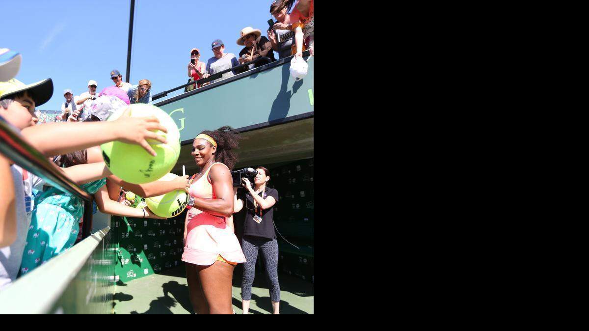 
Serena Williams, from USA, signing autographs to fans after defeating Catherine Bellis, from USA, 6-1, 6-1 during their third round match at the Day 7 of the Miami Open Tennis tournament at Crandon Park in Key Biscayne on Sunday, March 29, 2015.
