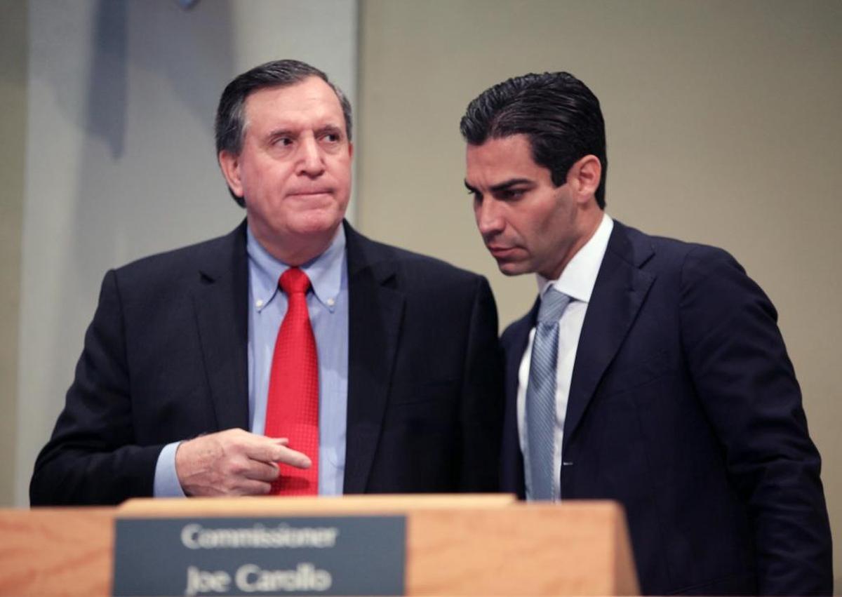 City of Miami Commissioner Joe Carollo and Mayor Francis Suarez talk during the City Commission meeting at Miami City Hall in Coconut Grove on Thursday, Dec. 14, 2017.