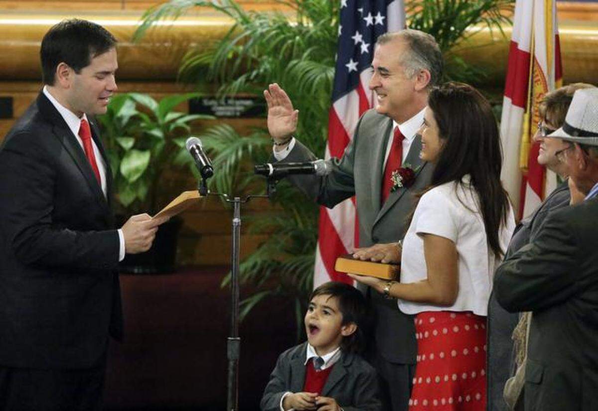 U.S. Sen. Marco Rubio, left, swears in Esteban “Steve” Bovo as vice chairman of the Miami-Dade County Commission.