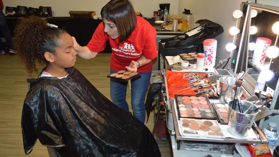 Evony Viera, 13, gets the star treatment by make-up artist Liza Horwitz before a professional photo shoot. Evony is one of the 25 foster children who will be featured in the Children's Trust Heart Gallery.