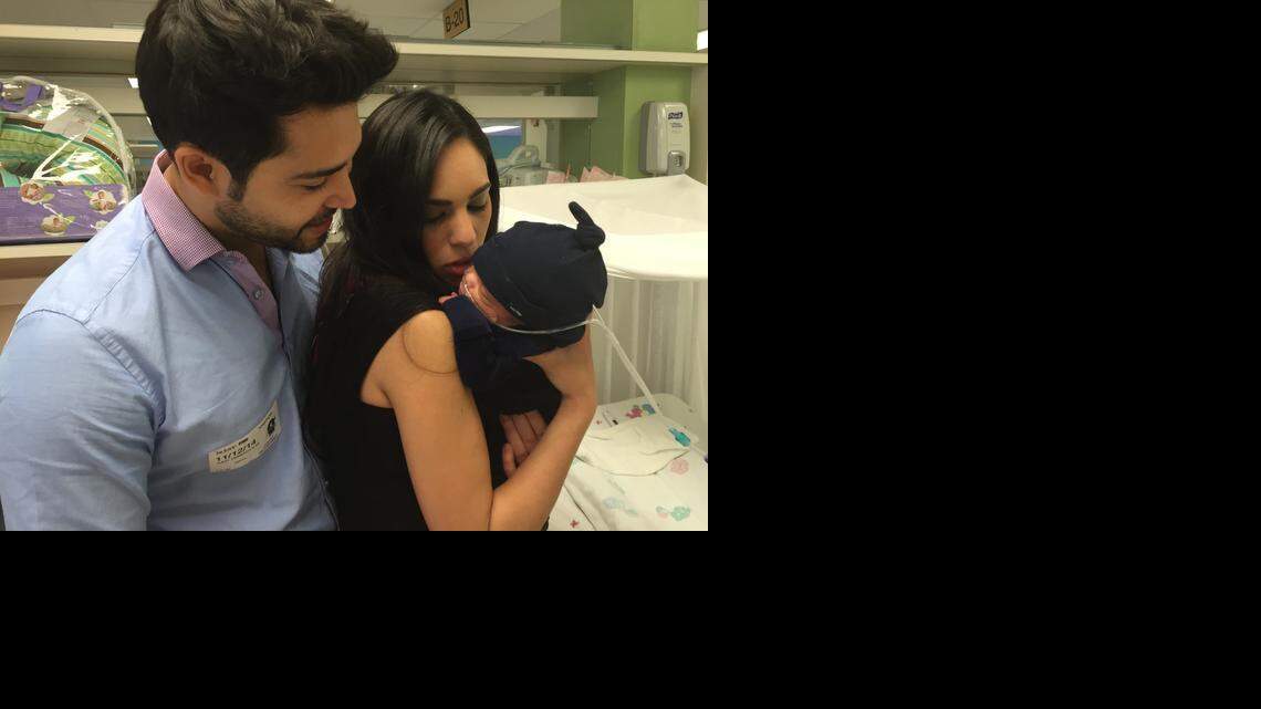 
David Gutierrez looks at his son Julian as his wife, Ivanna Cardenas-Gutierrez, soothes the baby. Julian is one the couple’s quadruplets, born Aug. 18.
