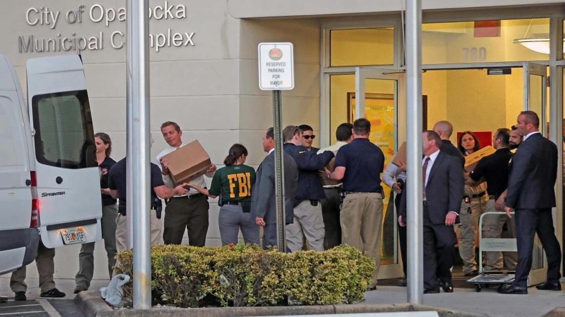 Dozens of FBI agents remove boxes of documents as evidence from the City of Opa-Locka Municipal Complex building which was raided Thursday, March 10, 2016, after two years of investigations.
