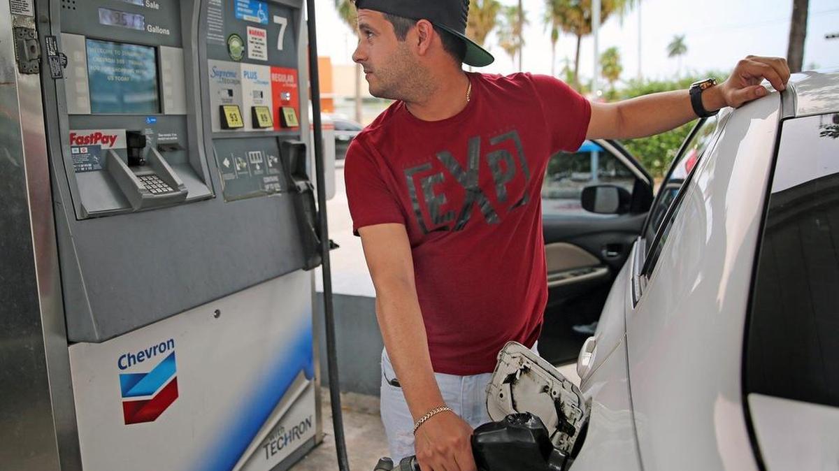 Motorist Hardy Monteagudo checks the meter as he pumps gas at a Chevron station in Miami Springs on Sept. 25. Experts say the slight bump in gas prices this week shouldn’t be a cause for alarm.