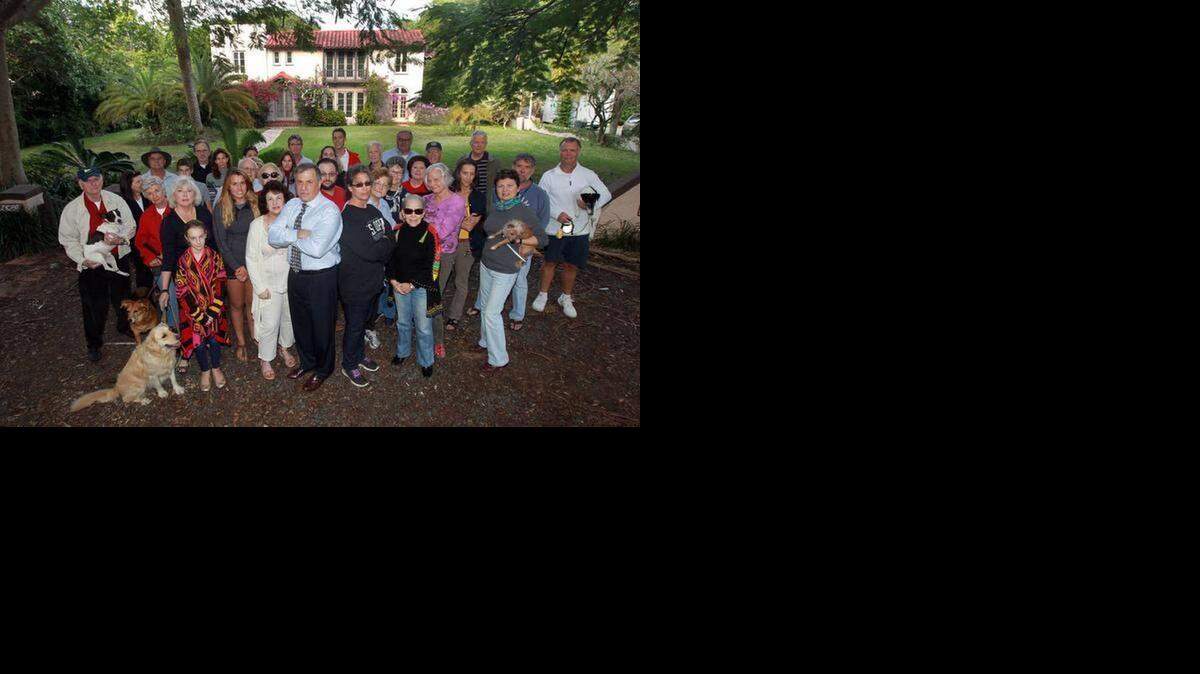 
Rick Zelman (front center with the tie) and Jennifer Beber (front and center next to Zelman in black) are among a group of neighbors who have sought to save a 1920s house in Coconut Grove by having it declared historic. 

