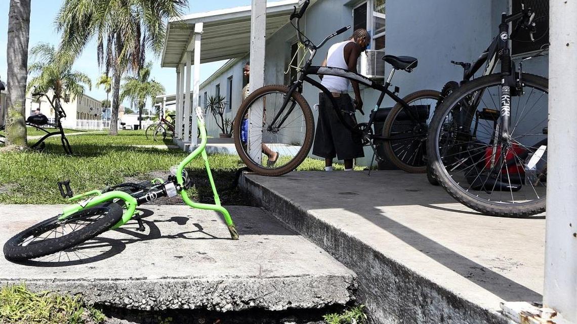 Residents of Liberty Square in Miami say rat holes, such as the gap between dirt and walkway at bottom of photo, proliferate in the Miami-Dade County public housing apartment complex. They say rats often make crawl spaces and work their way inside apartments.