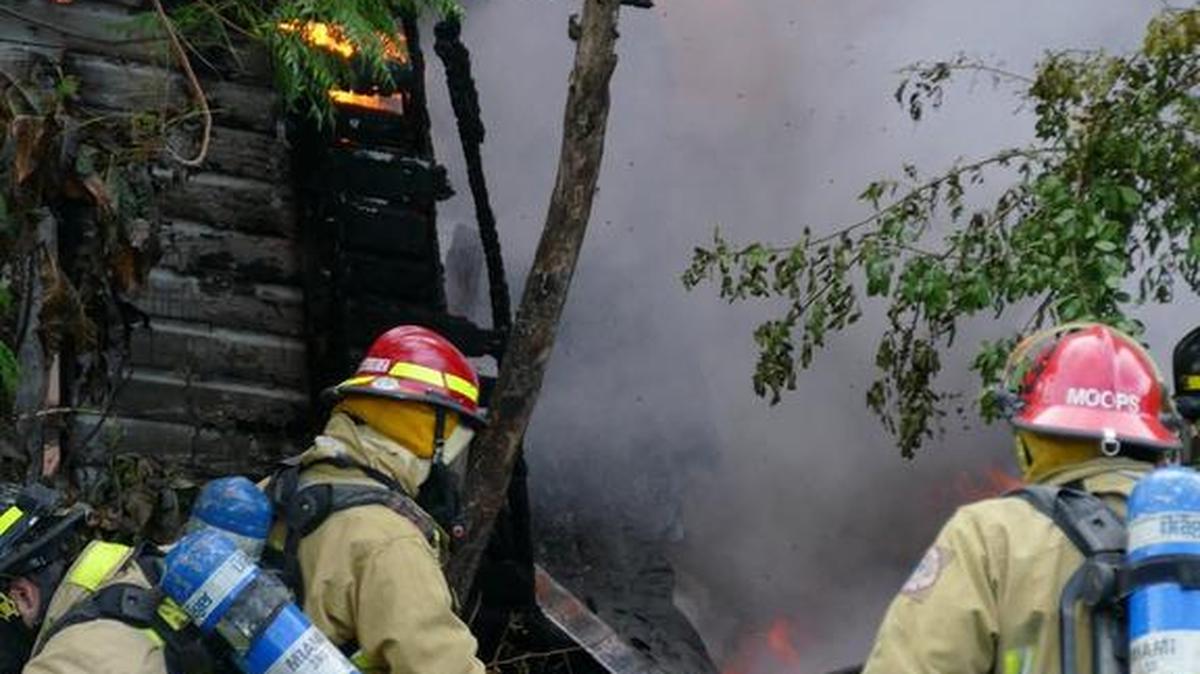 
Fire breaks out in a wooden frame home in the 8100 block of Northeast First Avenue as Miami Fire Rescue extinguishes the blaze Wednesday evening, Sept. 23, 2015.
