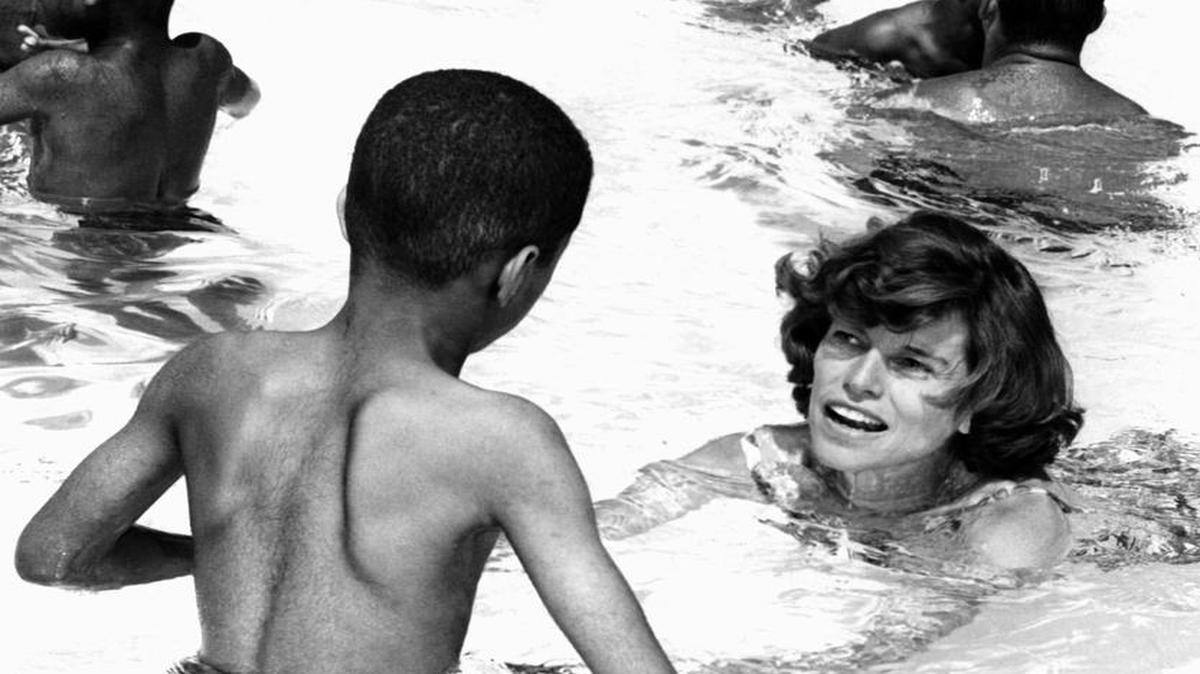 In this Aug. 21, 1964, file photo, Eunice Kennedy Shriver is shown swimming with youngsters in a pool at the day camp for intellectually challenged children in Fairmount Park in Philadelphia.
