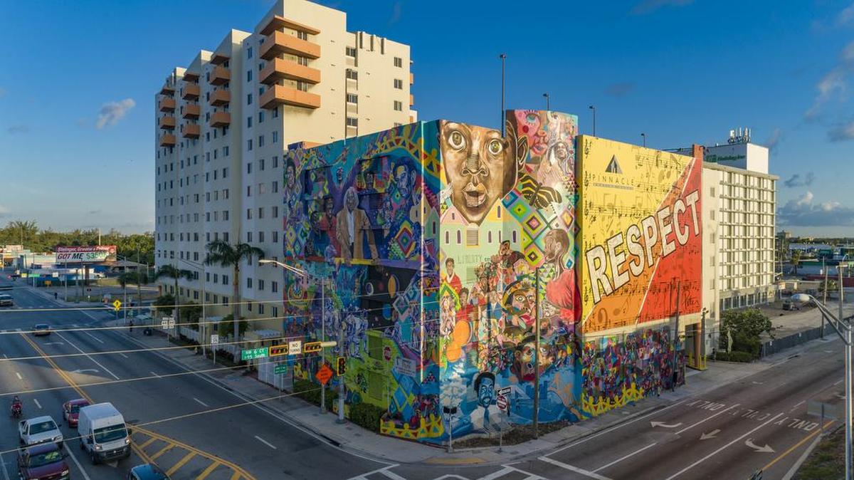 Artist Kyle Holbrook of Moving Lives of Kids created the nine-story ‘Liberty City Mural’ for the Liberty City Pinnacle Art in Public Places program.