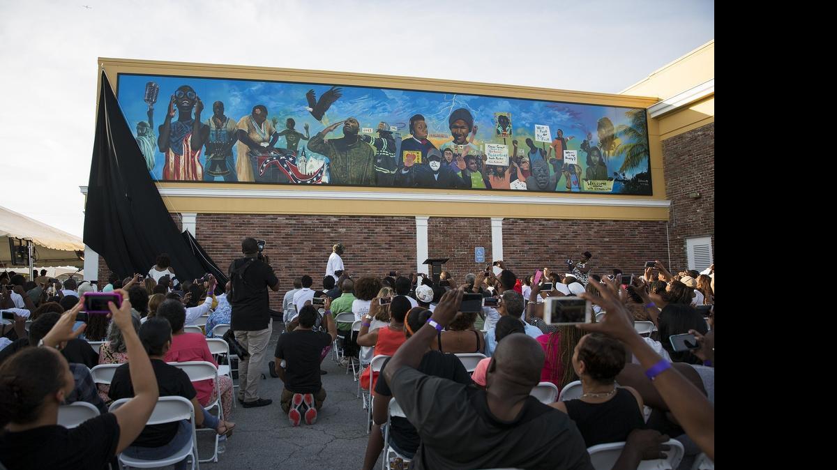 
The OneUnited Mural Project is unveiled at OneUnited Bank on Saturday, July 11, 2015.  During the mural project, 21 inner-city youth from nine South Florida high schools worked under the guidance of muralist Addonis Parker to research, design and create a public work of art utilizing the OneUnited Bank building as its canvas.
