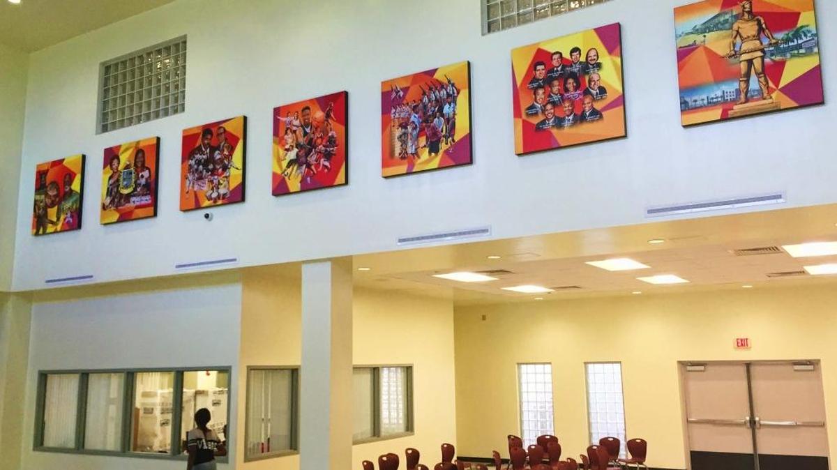 Artist C.J. Latimore’s murals hang at the new Miami Norland Senior High School.