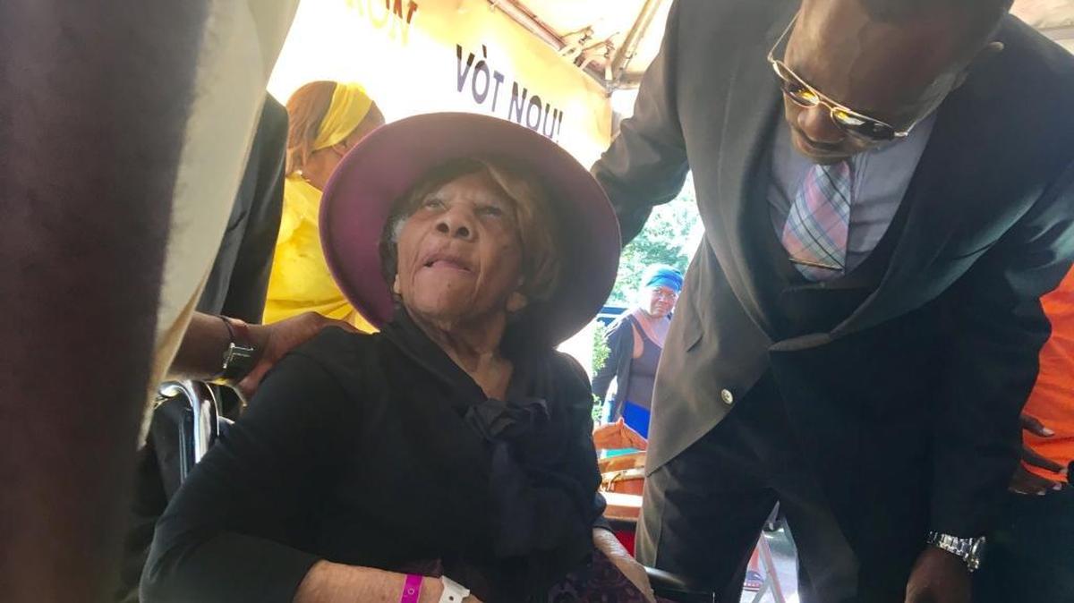 Desiline Victor, 105, with her son, Mathieu Pierre-Louis, Sunday at the North Miami polling place where she waited three hours to vote in 2012.