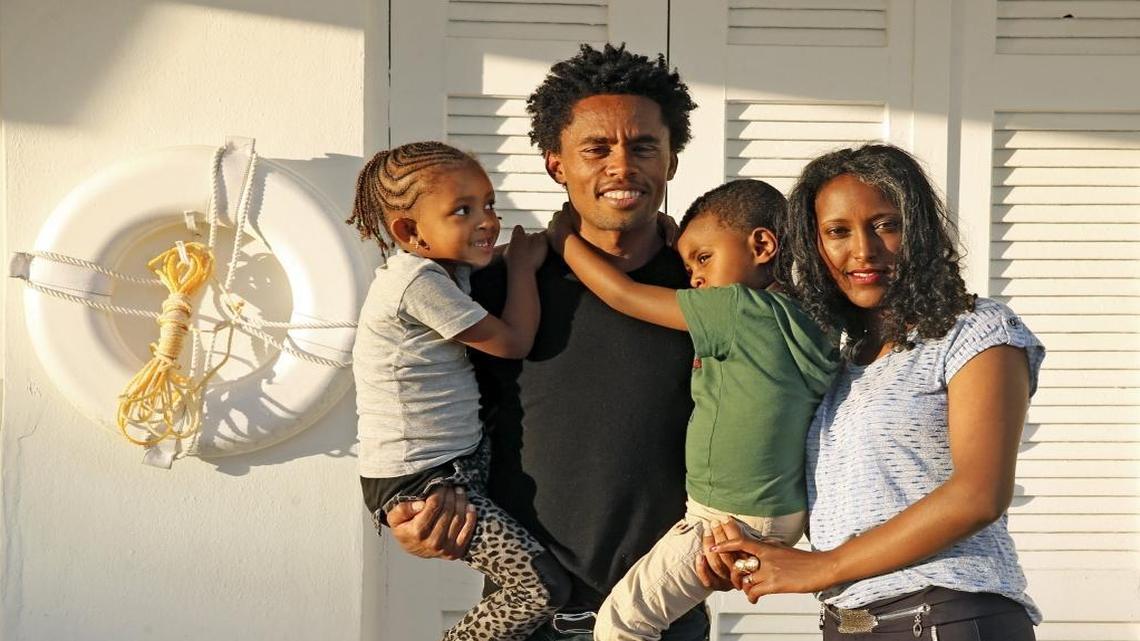 Marathoner Feyisa Lilesa, reunited with his wife, Iftu Mulisa, daughter, Soko, 6, and son, Sora, 3, in Miami Beach. They will go with him to Arizona, where he has lived since the Games.