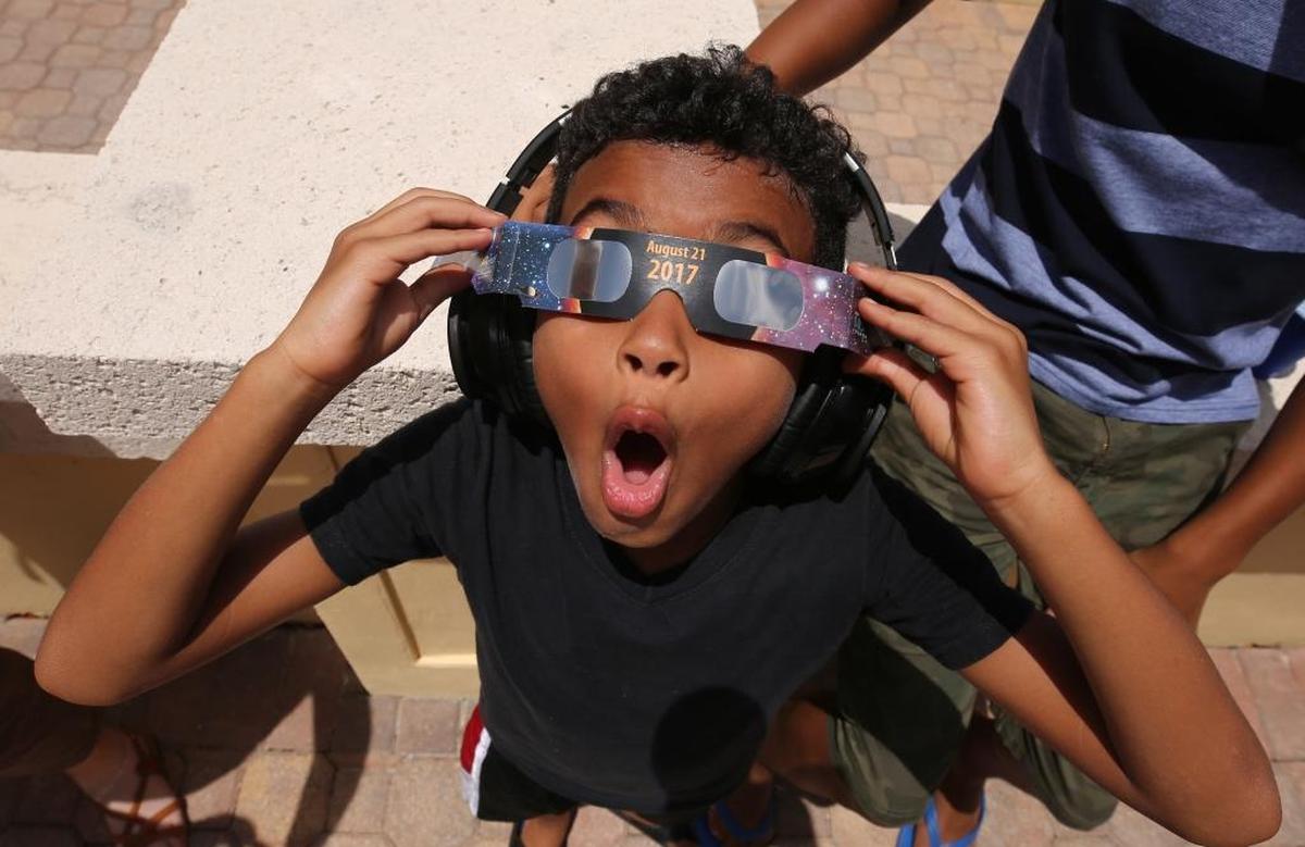 Josiah Garmon, 8, looks up at the Spanish River Library in Boca Raton to watch the eclipse. The library is an official site, having signed up with the STAR Library Education Network. It’s the first total solar eclipse to be visible from the continental U.S. since 1979 and the first to cross the U.S. from coast to coast in 99 years.