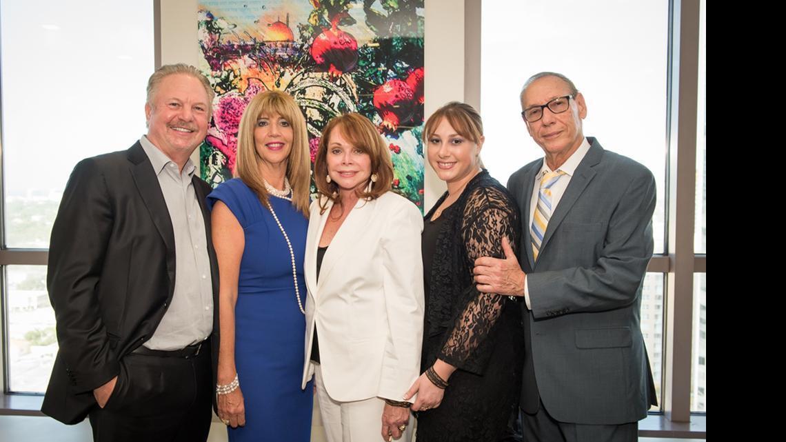 
CELEBRATING A LIFE: Gerald Greenspoon, Ellen Greenspoon, Shirley Sotloff, Lauren Sotloff and Arthur Sotloff pose in front of artist Tracy Ellen’s tribute to Steven Sotloff. 
