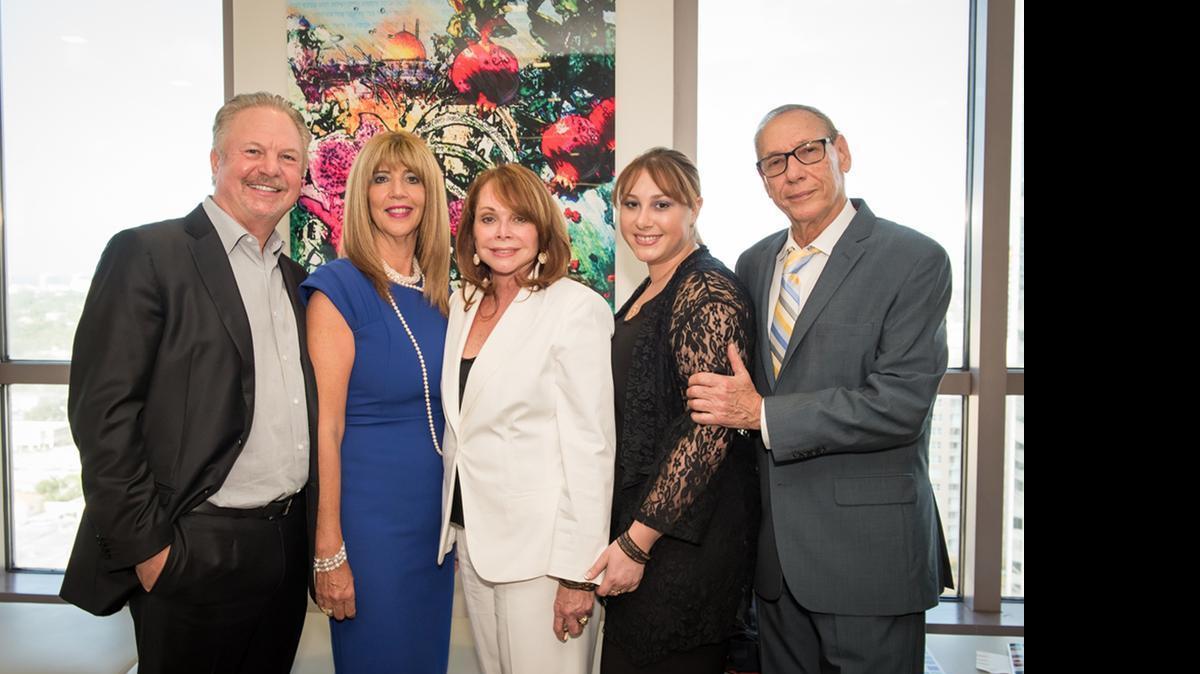 
CELEBRATING A LIFE: Gerald Greenspoon, Ellen Greenspoon, Shirley Sotloff, Lauren Sotloff and Arthur Sotloff pose in front of artist Tracy Ellen’s tribute to Steven Sotloff. 

