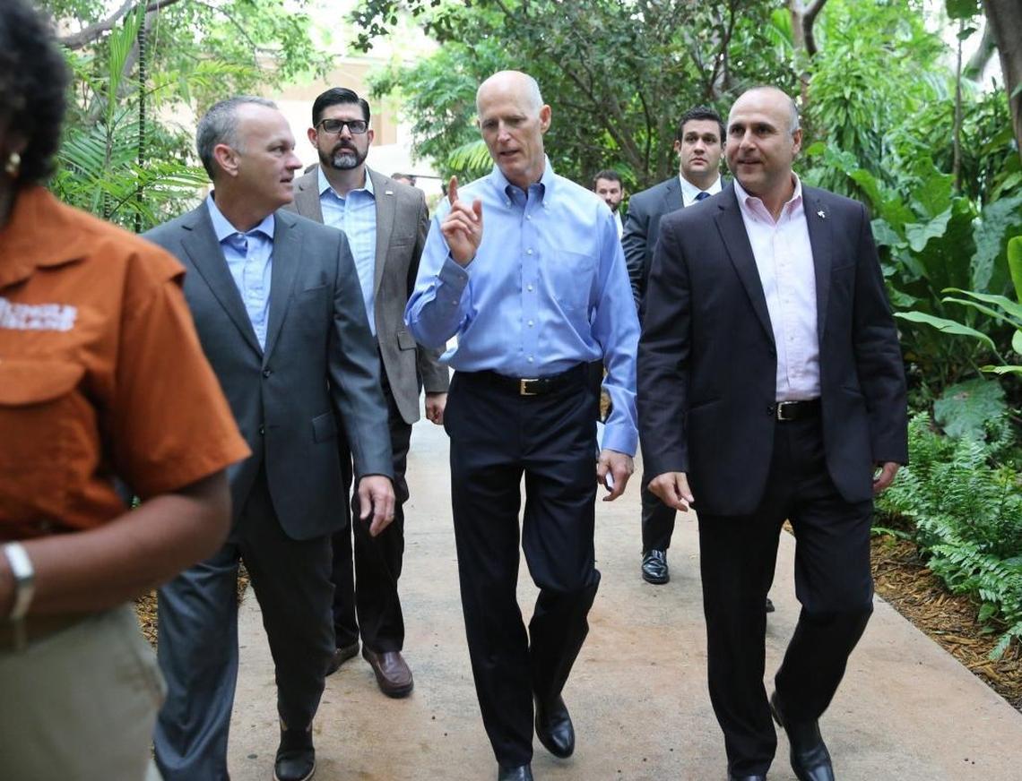 Governor Rick Scott, (center) walks along a path at Jungle Island with House Speaker Richard Corcoran, left, and Elie Mimoun, the chief operating officer of ESJ, the owning group of Jungle Island. Scott was at Jungle Island to launch a ‘victory tour’ Tuesday morning, June 13, 2017, to celebrate his successes at the recently concluded legislative session.