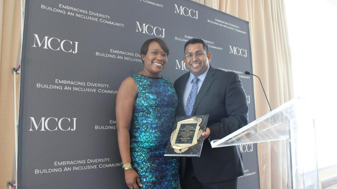 Joy Reid receives the Hank Meyer National Headliner Award in 2016 from MCCJ, formerly the Miami branch of the National Conference of Christians and Jews, from Johann Ali, the board chairman at the time.