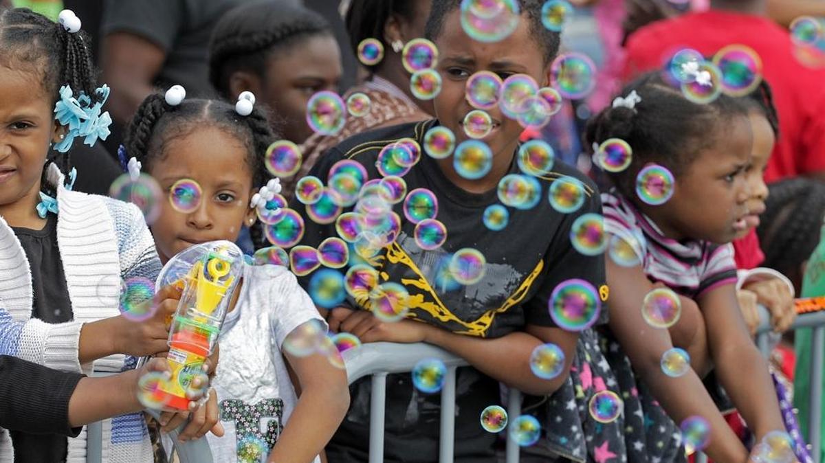 Children blow bubbles on the parade route on Jan. 18, 2016, in the annual Martin Luther King Jr. parade.