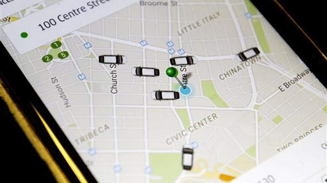 FILE - In this Wednesday, March 18, 2015, file photo, the Uber application displays cars available for a pick up at 100 Centre St on a cell phone in New York. In four years Uber has gone from nearly non-existent to more than 26,000 drivers, joining over 13, 000 New York City taxis.