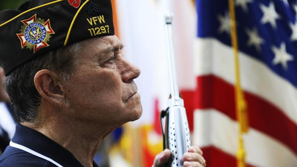Retired U.S. Marine Sgt. Hector Alvarez stands at attention with his rifle during the 2016 Memorial Day ceremony at Woodlawn Park Cemetery.