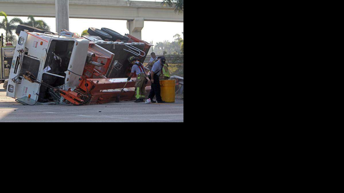 
An Under Power Corp. crane truck fell on its side in the 15900 block of NW 7th Avenue in a what appears to be a single vehicle accident with no injuries Wednesday Feb. 25, 2015. Miami-Dade Fire is applying an absorbent for fuel leakage.
