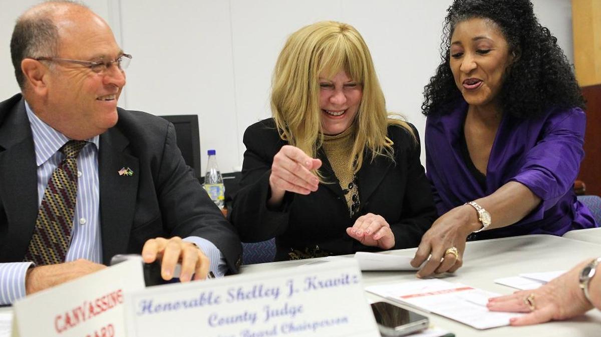 From, left, Judges Andrew Hague and Shelley Kravitz alongside the since-retired supervisor of elections, Penelope Townsley, review ballots during the 2014 general election in Miami-Dade County.