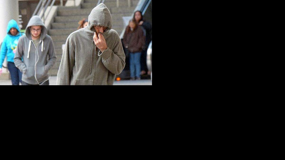 
Commuters bundle up at the downtown Miami Metrorail station during a January cold spell.
