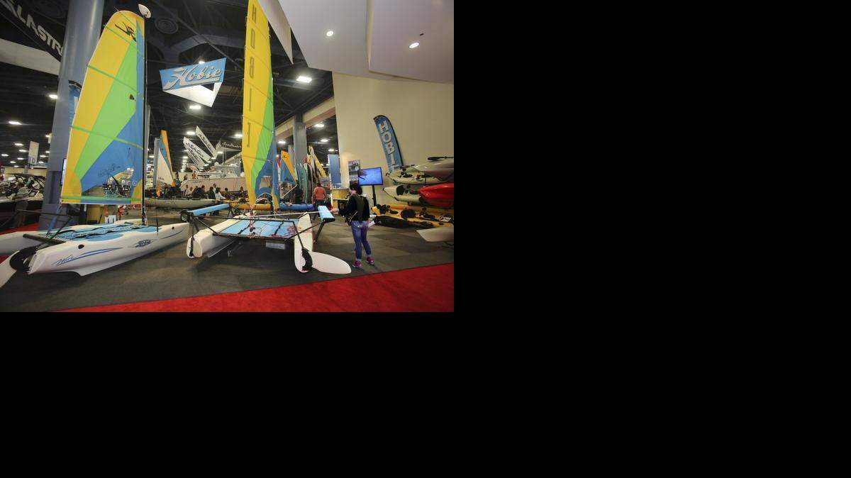 
Christina Contos of Orlando, right, tries out the tiller on a Hobie catamaran on Saturday, Feb. 14, 2015, at the Progressive Miami International Boat Show and Strictly Sail at the Miami Beach Convention Center. The annual show continues through Monday, Feb. 16, 2015 at 1901 Convention Center Dr.

