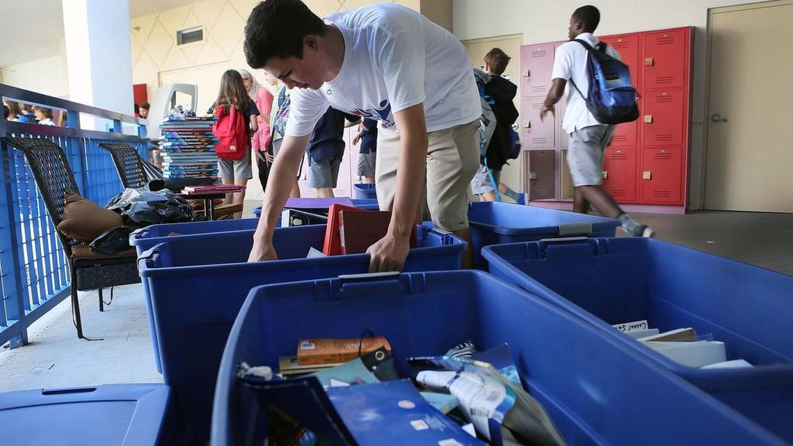 Blaise Pronesti, who organized the volunteer effort at Miami Country Day School, sorts through school supplies.