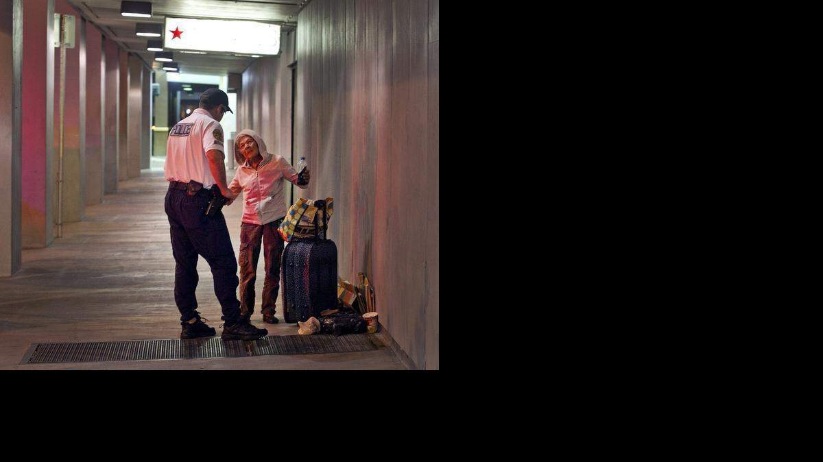
Miami Police officer Gregg Vassari asks a homeless woman in downtown Miami on Tuesday, February 17, 2015, if she would like to move to a shelter as Miami’s police outreach team works with the homeless by offering shelter in the Mat Program. If a proposed new law is approved next month it would essentially outlaw homelessness by banning people from sleeping on public property with pillows, blankets and other everyday items.

