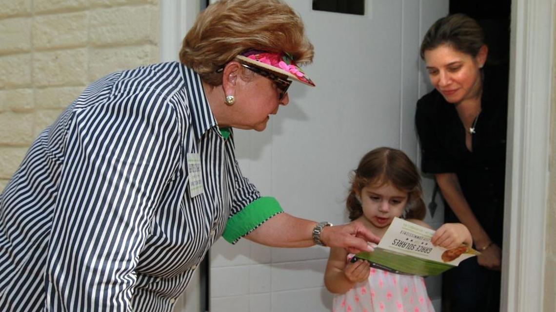
Grace Solares, (left) is a candidate for a Miami Commission seat representing downtown. She is here talking to two year old Hannah Brody, and her mother Yeleny Suarez. Solarez was knocking on doors and talking to voters on Aug. 19.
