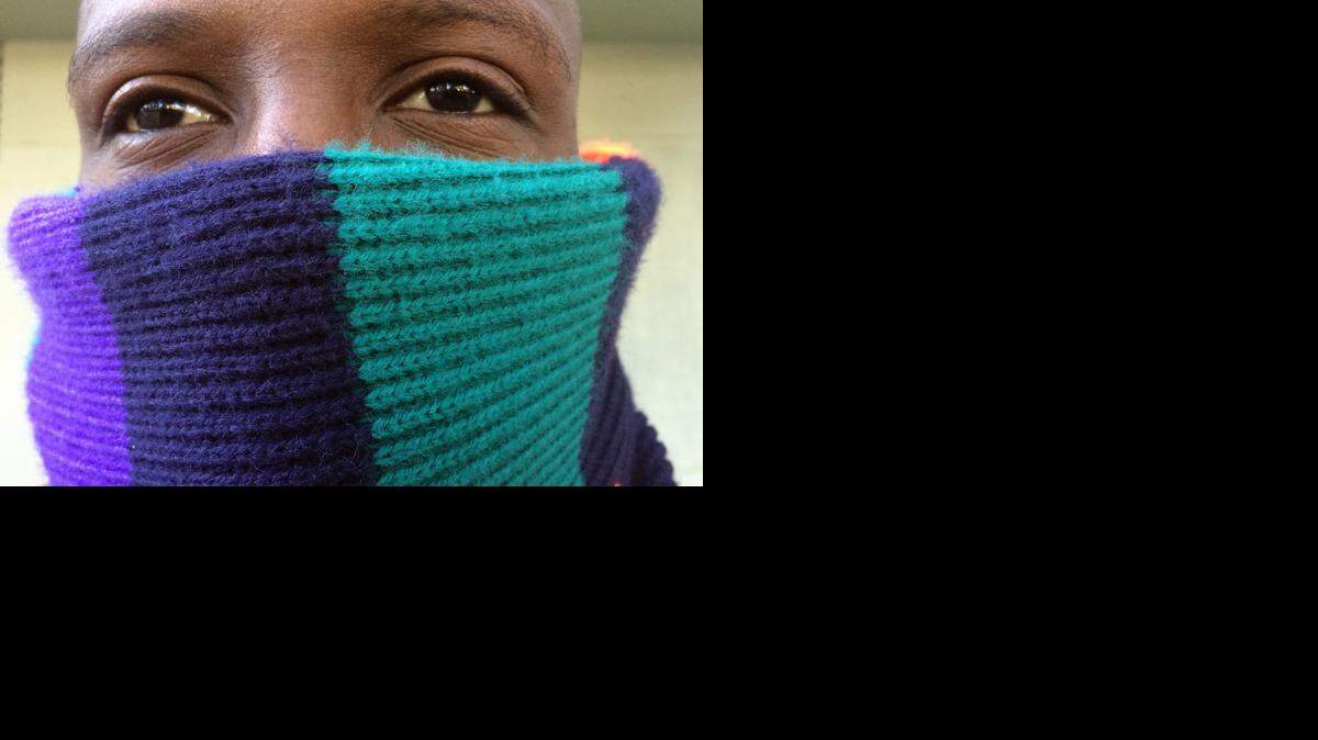 
School security guard Autrell Reid is well-prepared for the cool weather while standing watch over school children as they arrive at school on Wednesday, Dec. 10, 2014.

