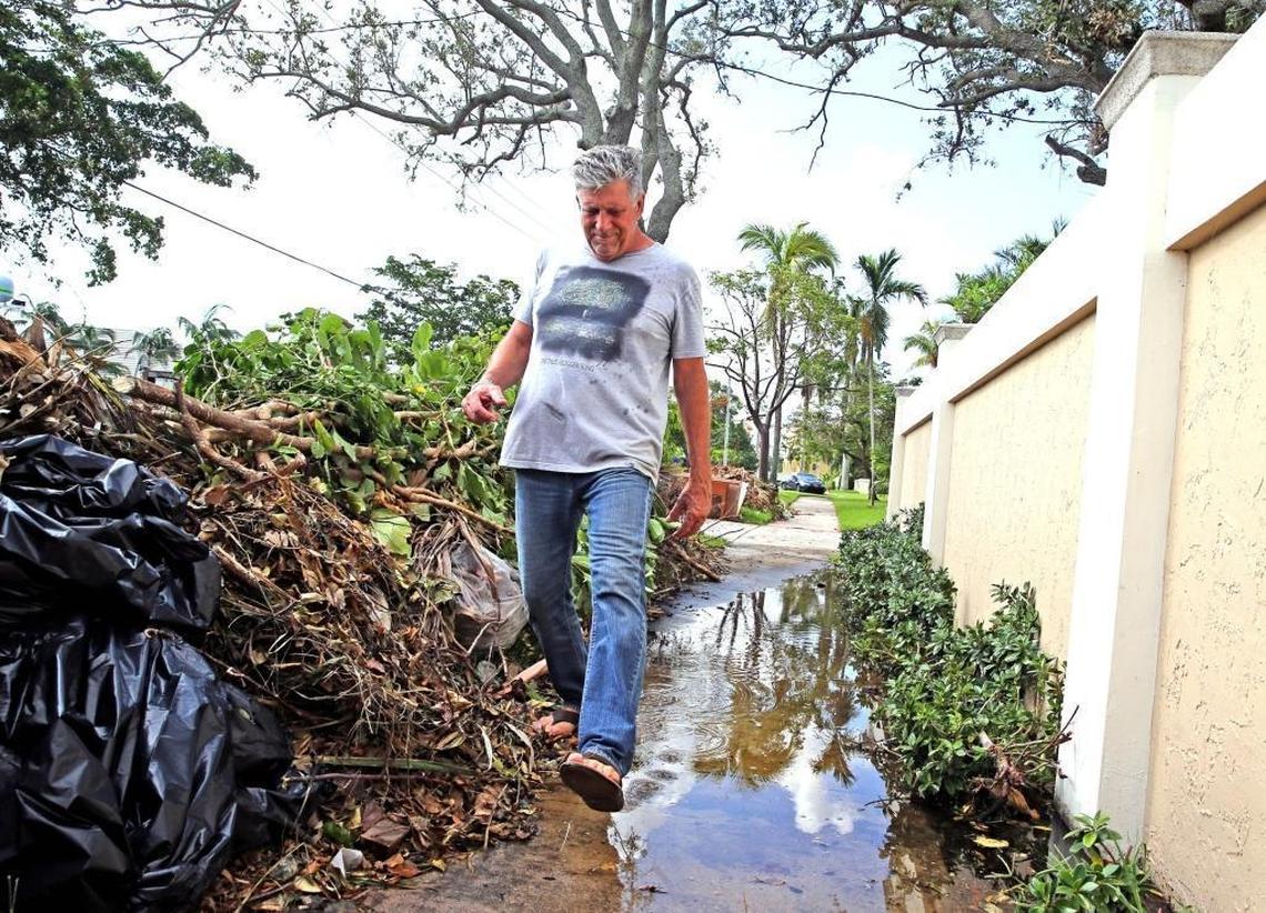 Steve Poskoski walks along the flooded broken sidewalk in front of his Cordova Road home in Fort Lauderdale, Tuesday, Sept. 19, 2017. The King Tide has worsened in the last several years, flooding streets and yards in the lower elevations in South Florida.
